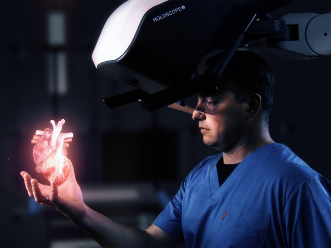 Physician using Holoscope-i with heart hologram depiction in hand