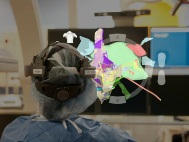 Surgeon wearing headset looks at AR model 