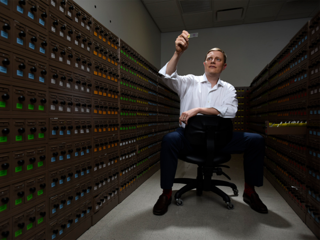 David Spetzler holding microscope slide