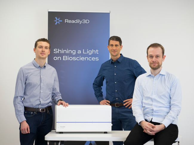 The three co-founders of Readily3d standing with the Tomolite printer