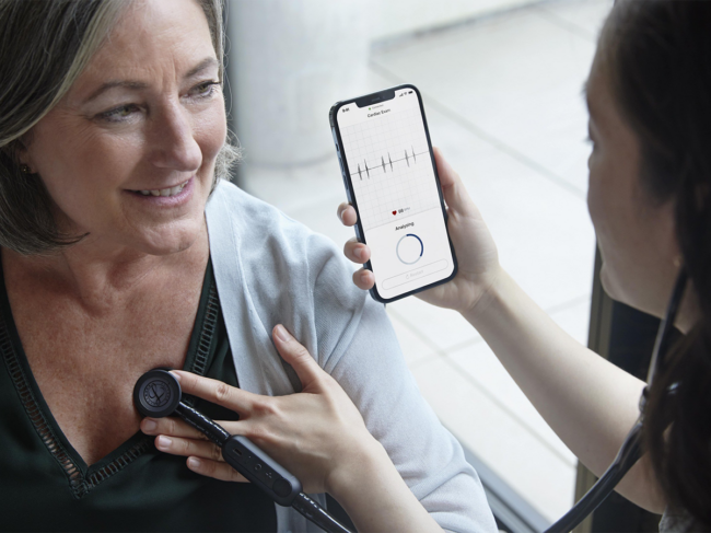 Doctor uses Eko app while listening to patient's heart