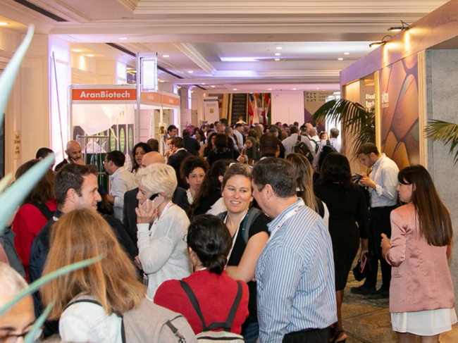 People congregating in the conference hallway