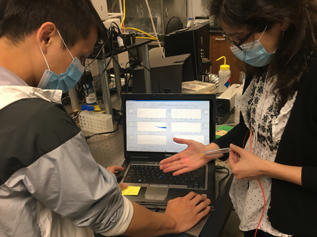 Researchers in lab demonstrating technology