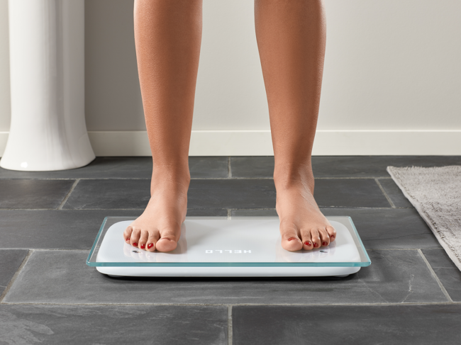 Person standing on Bodyport scale in bathroom