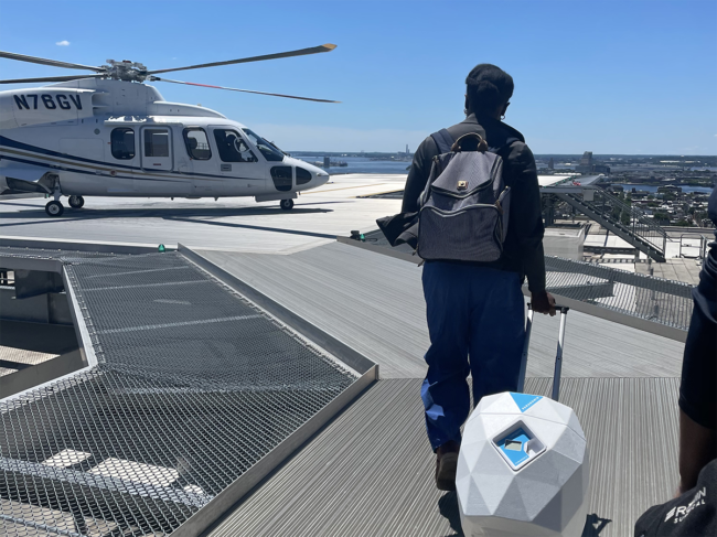 Man walking with Lungguard toward helicopter