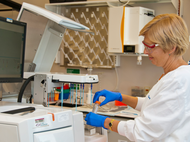 A technician preparing to run microbial genomes on the Roche 454 sequencing platform at the Advanced Technology Research Facility.