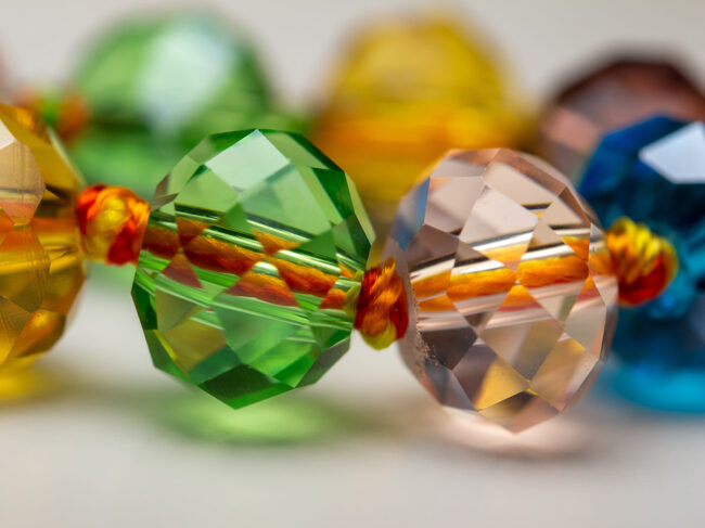 Close-up photo of multi-colored beads threaded onto a string