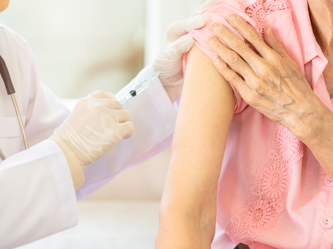 Older patient receiving shot