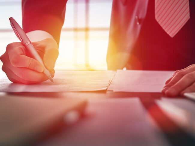 Businessman signing documents