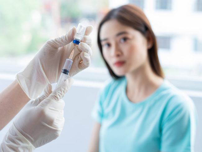 Woman about to receive a vaccine