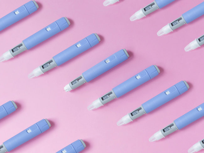 Autoinjectors on pink background