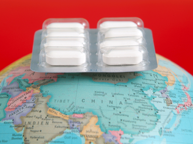 Blister drug pack atop globe