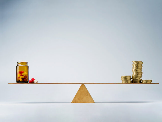 Seesaw with pill bottle and coins