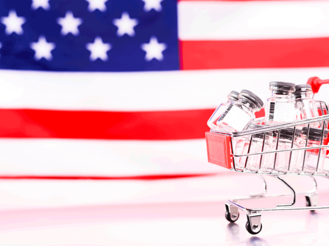 US flag, shopping cart of vials 