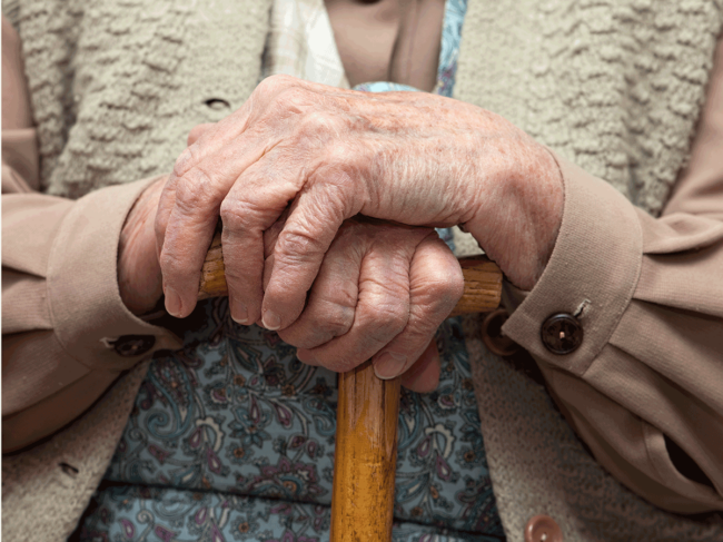 Older person holding cane