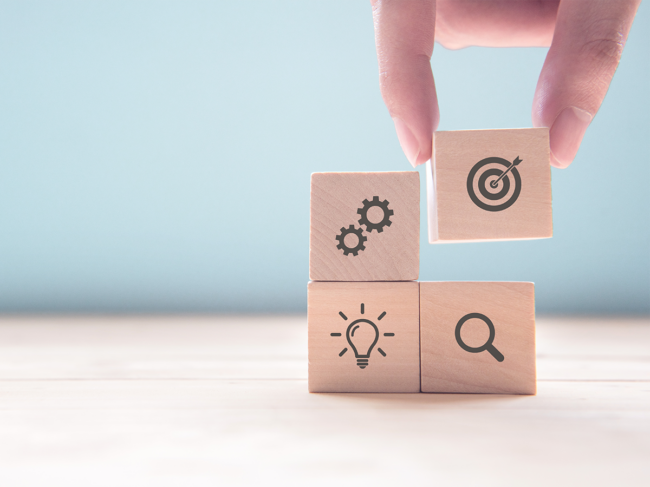 Blocks with gears, lightbulb, target, magnifying glass 