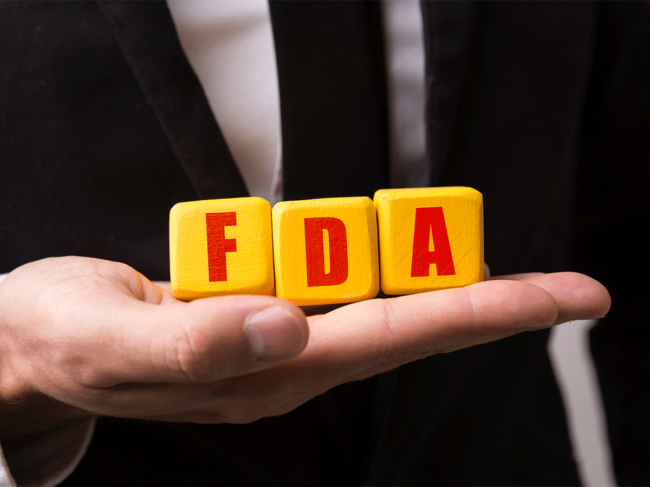 Hand holding FDA blocks