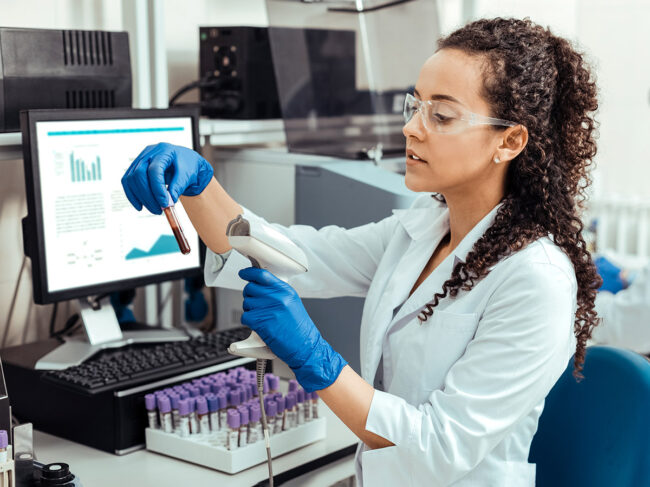 Woman scanning test tubes in the lab