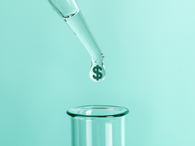 Dollar sign droplet above test tube