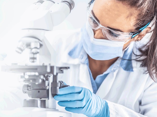 Scientist in lab with microscope 