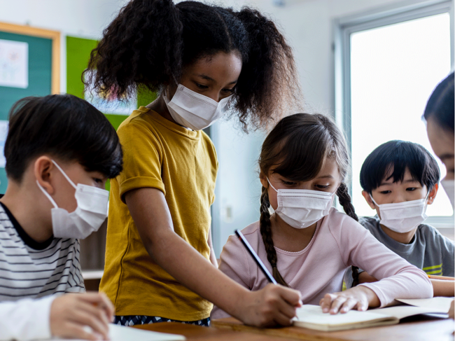 Children in classroom wearing masks