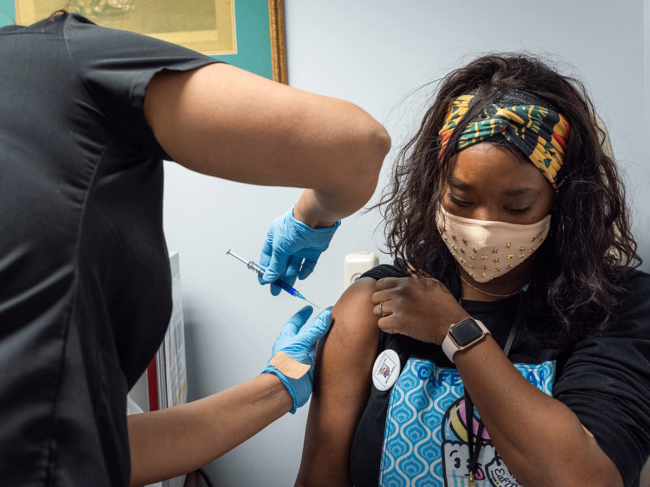 Woman receiving COVID-19 vaccine