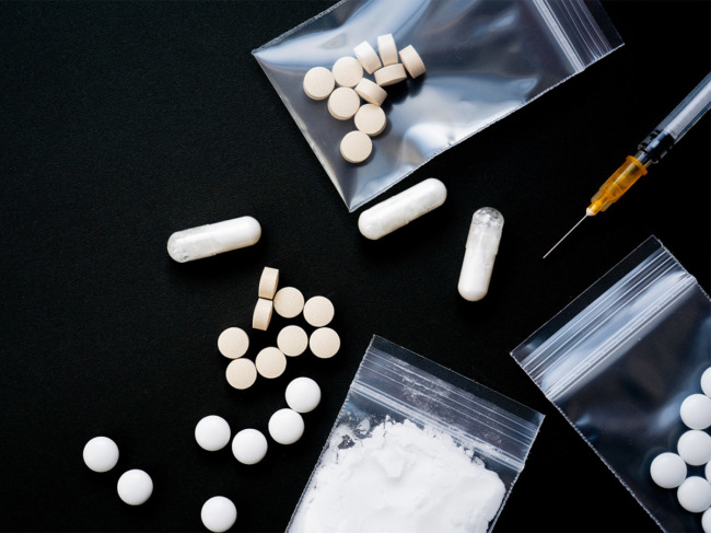 Various pills and powders in small plastic ziplock bags