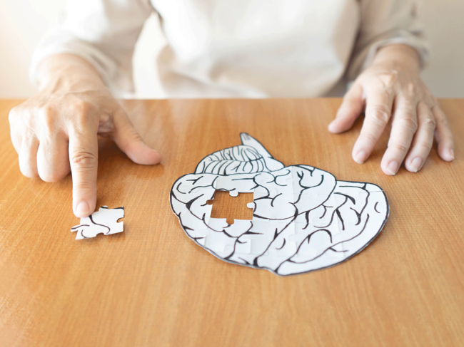 Elderly woman and jigsaw puzzle