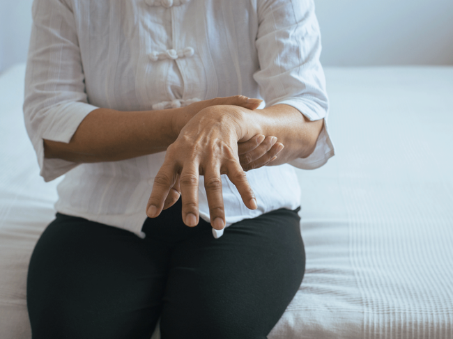 Woman steadying hand tremor