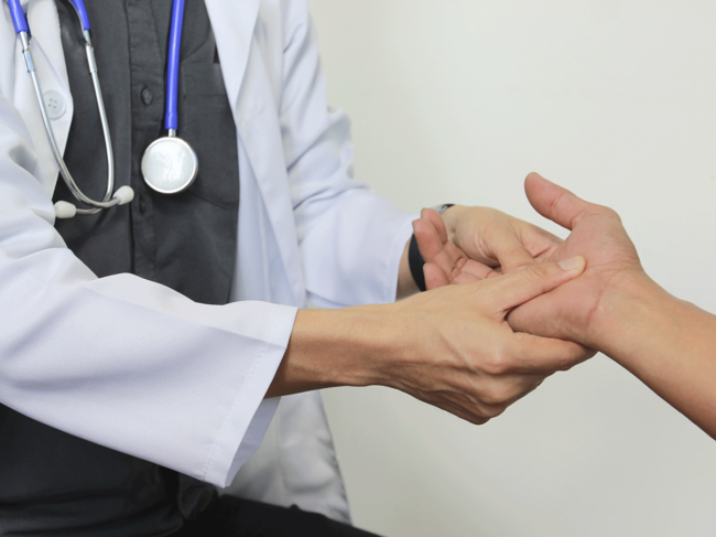 Doctor examining patient's hand