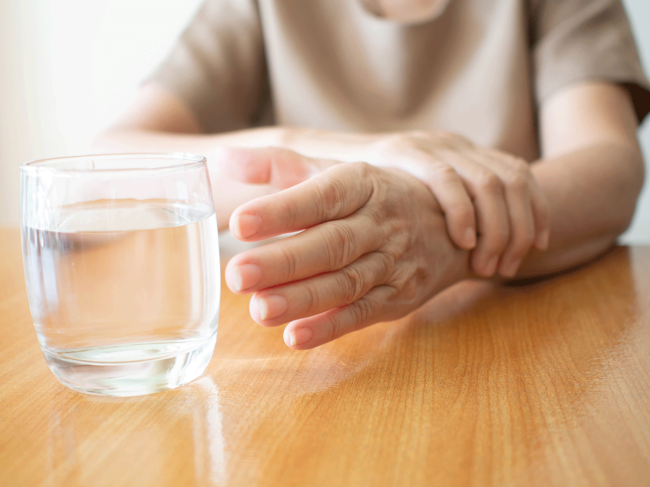 Steadying hand while reaching for glass