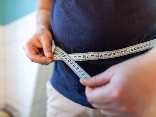 Man measuring waist