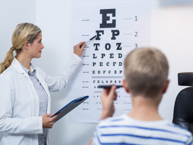 Child reading eye chart