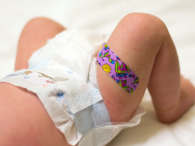 Baby with bandage on thigh