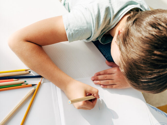 Child drawing with pencil